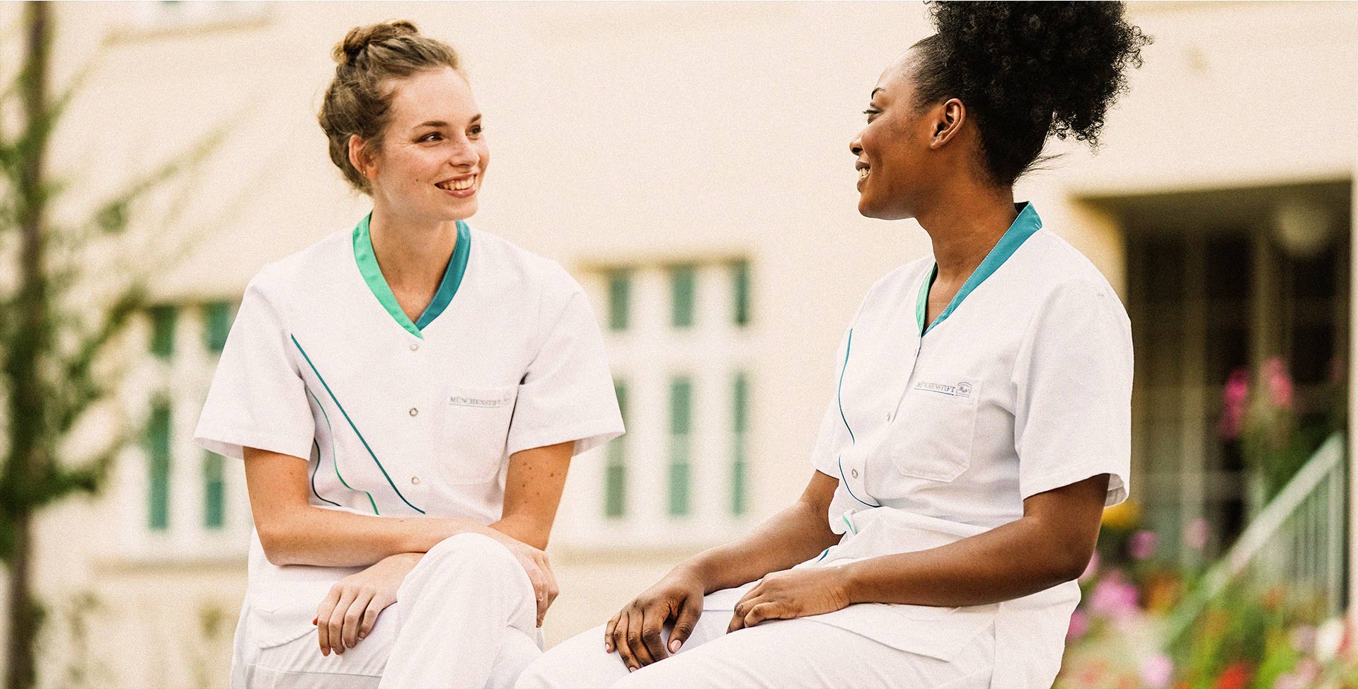 Lächelnde Krankenschwestern unterhalten sich im Freien